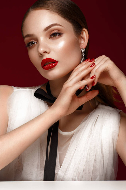 Beautiful girl in white dress with classic make-up and red manicure. Beauty face. - Фото, зображення