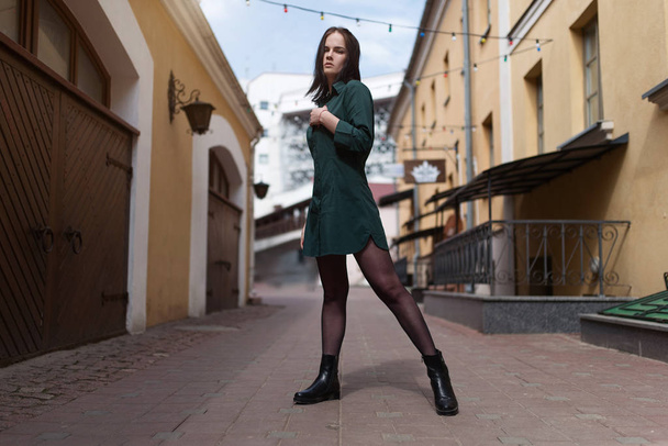 Passionate young girl posing at the background of old street - Valokuva, kuva