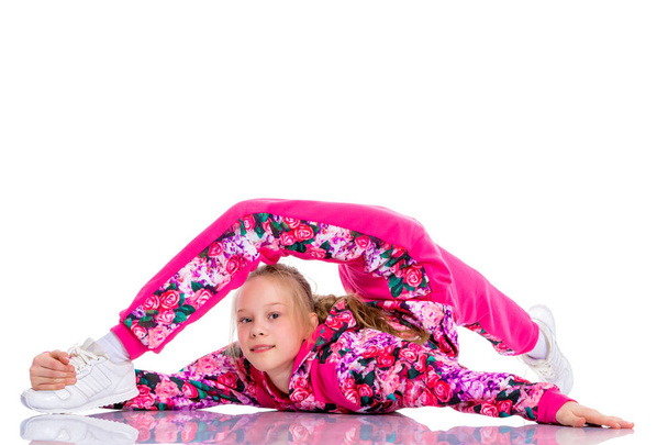 The gymnast perform an acrobatic element on the floor. - Zdjęcie, obraz