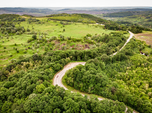 Winding road trough the forest on a hill top - Zdjęcie, obraz