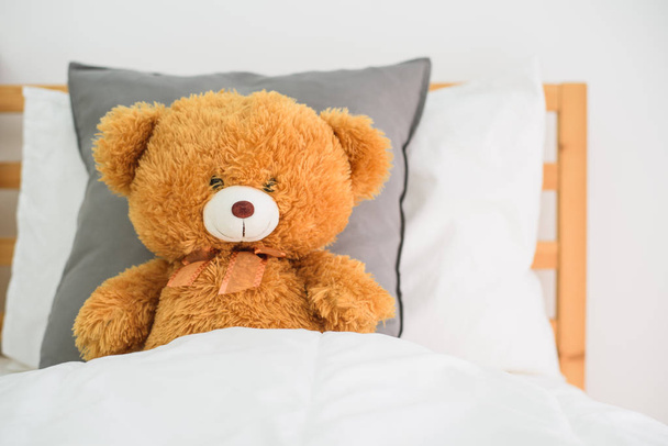 Teddy bear on the bed - Фото, изображение