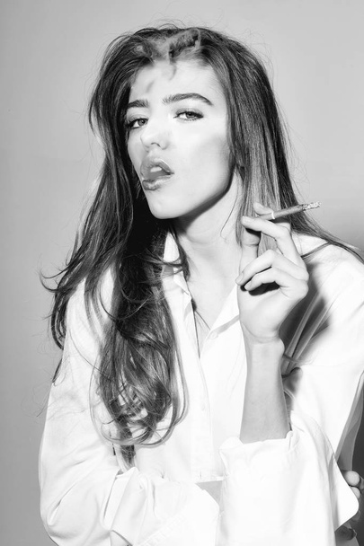 pretty sexy woman with long hair smoking cigarette in shirt - Valokuva, kuva