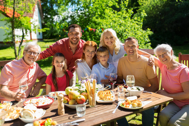 happy family having dinner or summer garden party - Foto, imagen