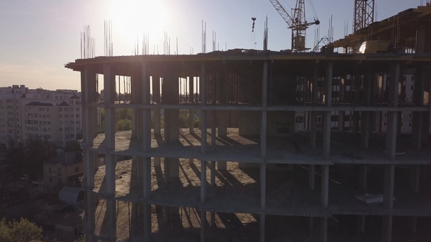 Aerial view of building cranes and buildings under construction - Filmati, video