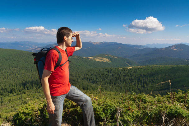 man stands on a peak of mountains and looking the scenery - Foto, imagen