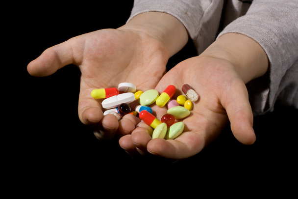 kleurrijke pillen op handen - Foto, afbeelding