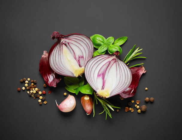 red onion and spices on black background, top view - Foto, imagen