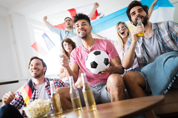 Soccer fans emotionally watching game and screaming in the living room - Foto, Bild