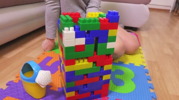Woman finishing build construction of colorful toy bricks - Video