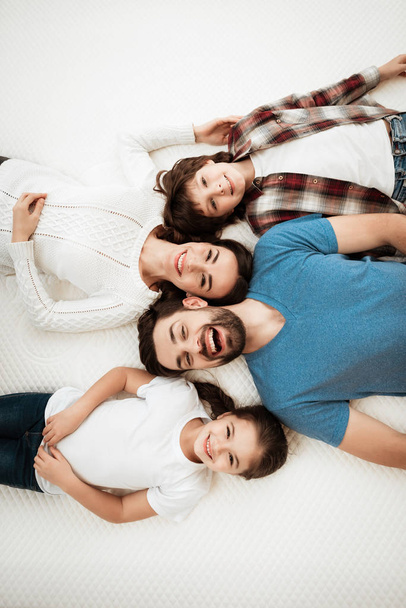 family choosing soft mattress in orthopedic furniture store - Foto, Imagem