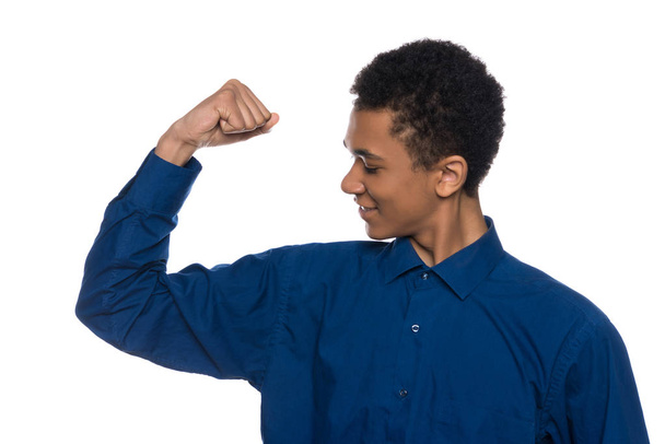 African American teenager shows muscles on arm. - Photo, Image