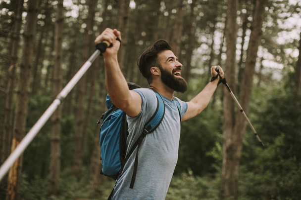 Side view at young bearded hiker in mountain - Foto, imagen