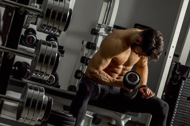 Handsome young man training in the gym - Photo, Image