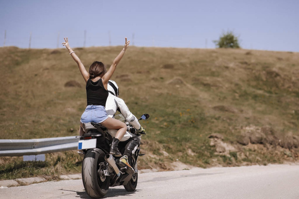 Beautiful couple traveling with a sports motorcycle - Foto, immagini