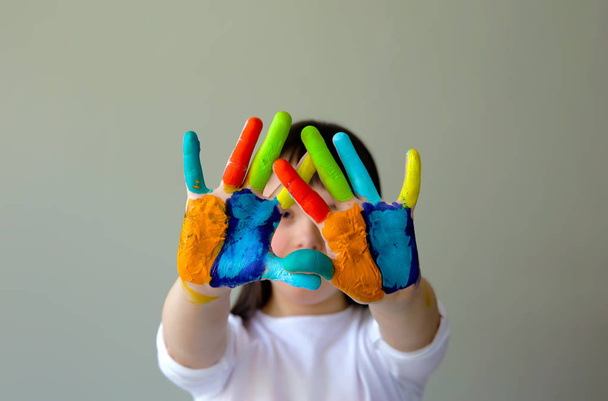Cute little girl with painted hands. - Photo, Image