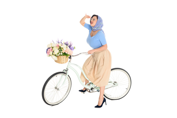 full length view of stylish pin up woman sitting on bicycle and looking away isolated on white - Photo, Image