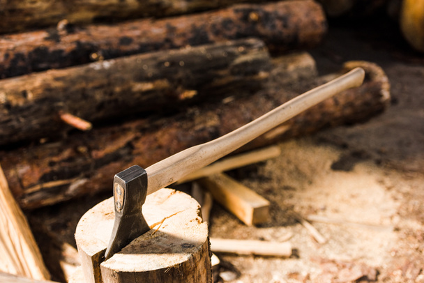 close up view of sticking axe in log at sawmill  - Photo, Image