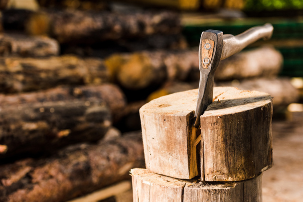 closeup view of sticking axe in log at sawmill  - Valokuva, kuva