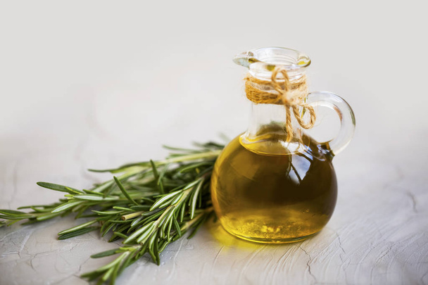 Olive oil bottle with rosemary herb - Photo, image