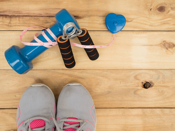 blue dumbbell and measure and shoes sport on wooden background with copy space - Φωτογραφία, εικόνα