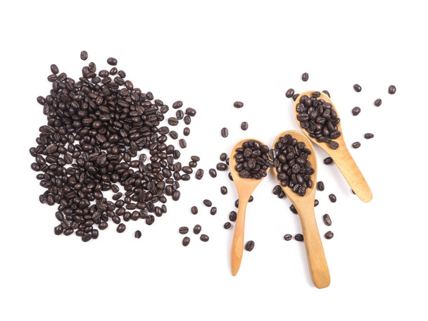 Cup of coffee and coffee beans on wooden spoon on white background - Photo, Image