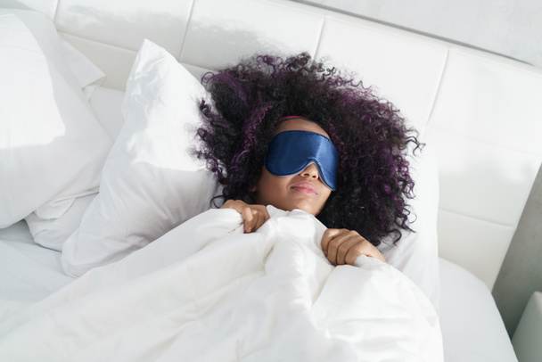 Tired Black Girl Waking Up In Bed With Sleep Mask - Foto, imagen