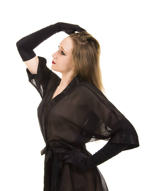 Beautiful young girl in black tunic and black gloves.Posing in Studio on white background isolated image. - Foto, imagen