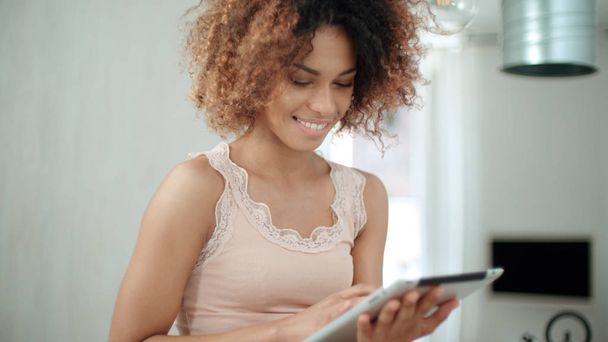 Smiling happy afro american woman using pc tablet at home. - Valokuva, kuva