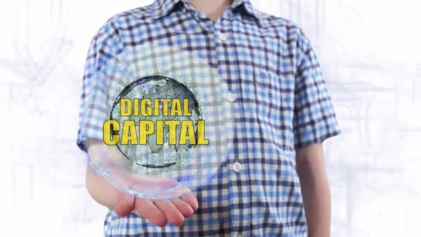 Joven muestra un holograma del planeta Tierra y texto Capital digital
 - Metraje, vídeo