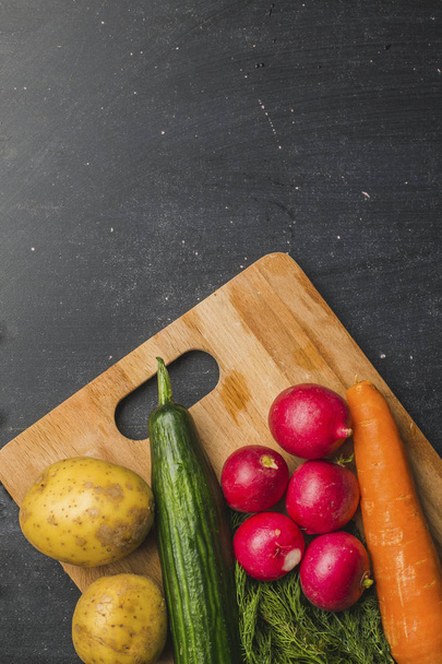 Food background. Fresh farmer vegetables at dark table. Space for text. - Фото, зображення
