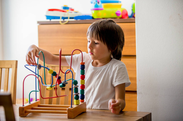 Preschool child, playing with toys in a sunny room, child development - Fotoğraf, Görsel