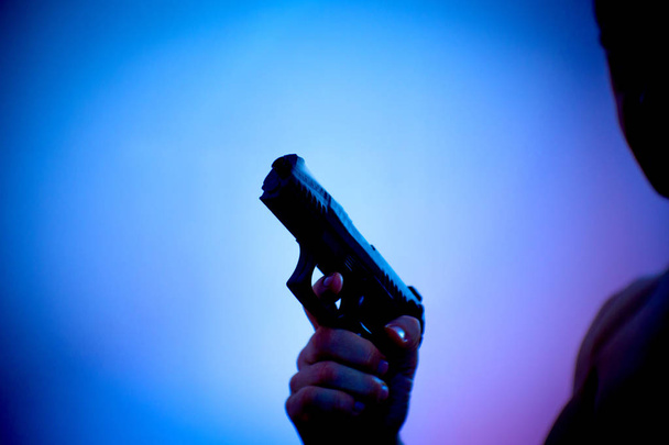 Gun held by a mans hand - Foto, Imagen