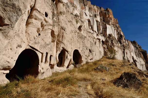 Cave houses and christian temples cut in pink tufa stone,Ihlara Valley,Cappadocia, gorge,Turkey - Zdjęcie, obraz