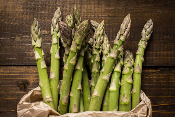Bunch of Fresh Green Asparagus in Paper Bag. Copy Space. - 写真・画像