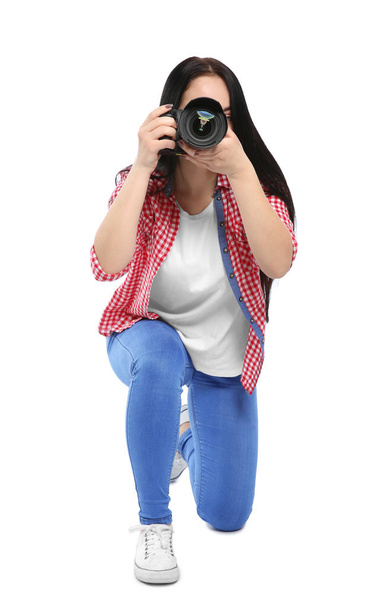 Female photographer with professional camera on white background - Photo, image