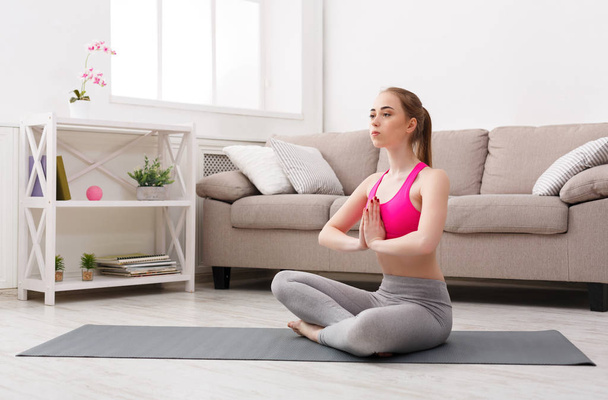 Woman training yoga in lotus pose - 写真・画像
