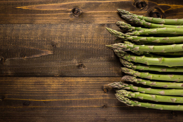 Fresh Green Asparagus on Dark Wooden Background. Copy Space. - Photo, Image