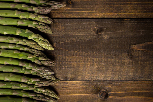 Fresh Green Asparagus on Dark Wooden Background. Copy Space. - Valokuva, kuva