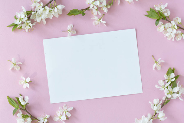Spring concept. Flat-lay of blossom and card over light pink background, top view with space for your text. - Фото, зображення