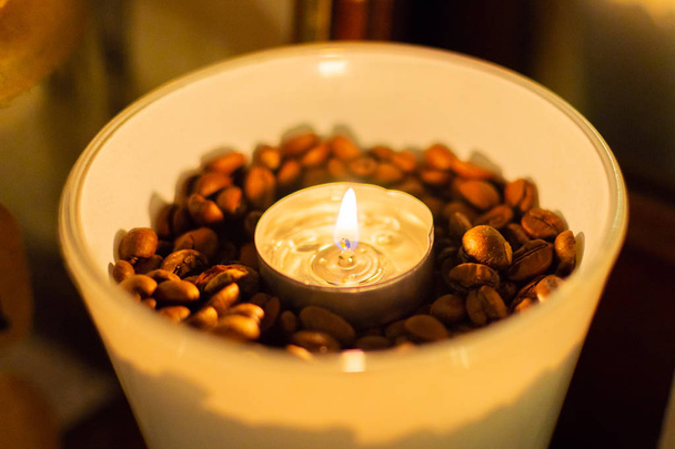 Coffee beens and candles in a glass vase. - Photo, Image