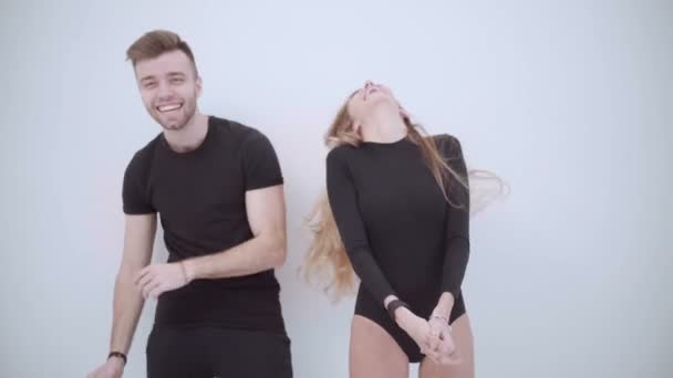 Young joyful couple have fun dancing. Geek couple silly dancing. Couple dancing in pajamas. Sexy woman dancing. - Video, Çekim