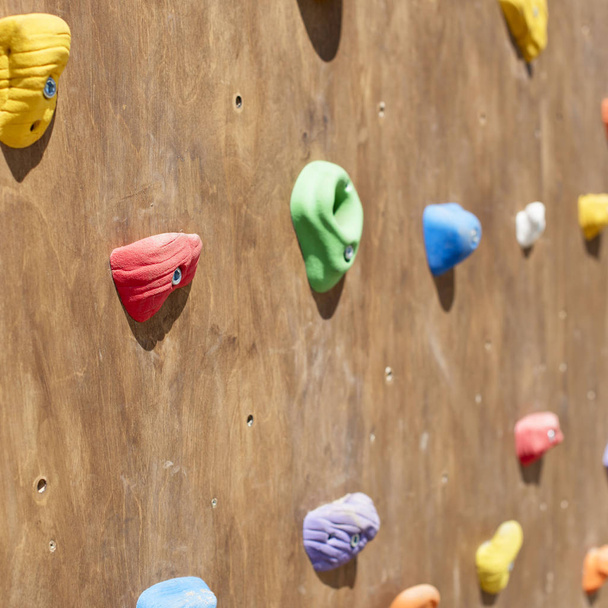 Wooden wall for climbing close up. Sports extreme multicolored background - Photo, Image