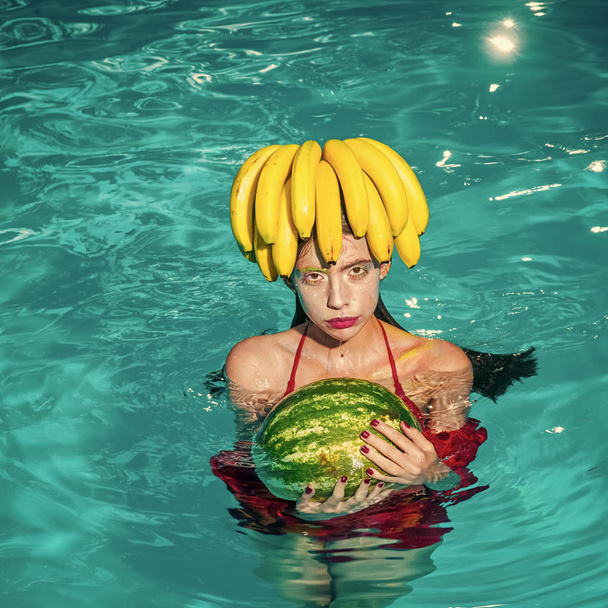 Fashion woman watermelon and banana enjoy in swimming pool. - Foto, immagini