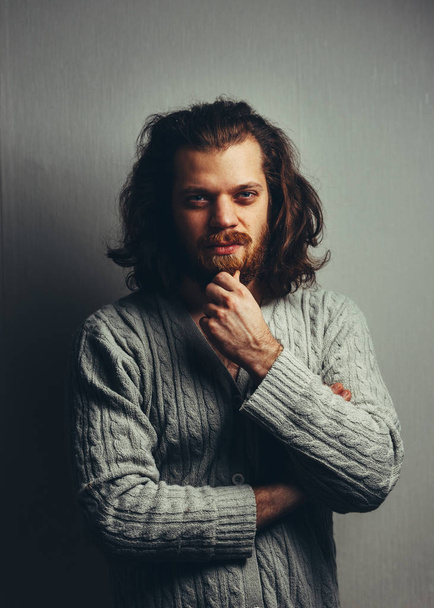 Handsome man with a beard and long hair. Creative portrait - Foto, Imagen