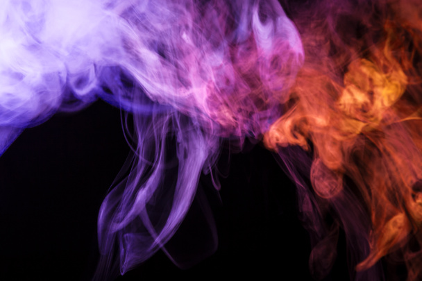 Colorful blue, pink and red smoke  on a black isolated background. Background from the smoke of vap - Fotó, kép