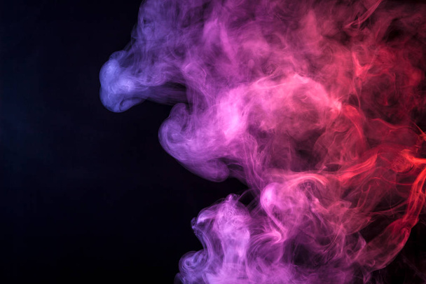 Nuage de fumée rose, bleu et rouge de fond isolé noir. Contexte de la fumée de vape
 - Photo, image