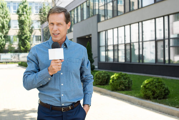 professional mature news reporter talking with microphone    - Photo, Image