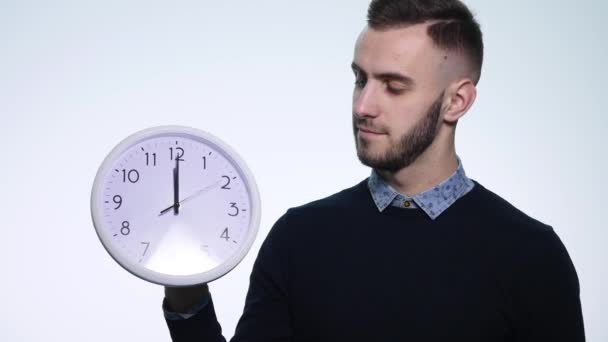Man holding clock on isolated white background - Imágenes, Vídeo