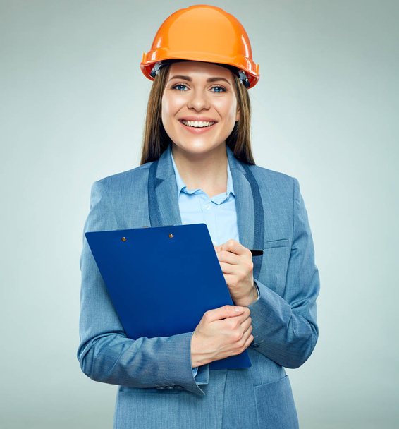 Smiling businesswoman builder holding clipboard with contract and pen  - Fotó, kép