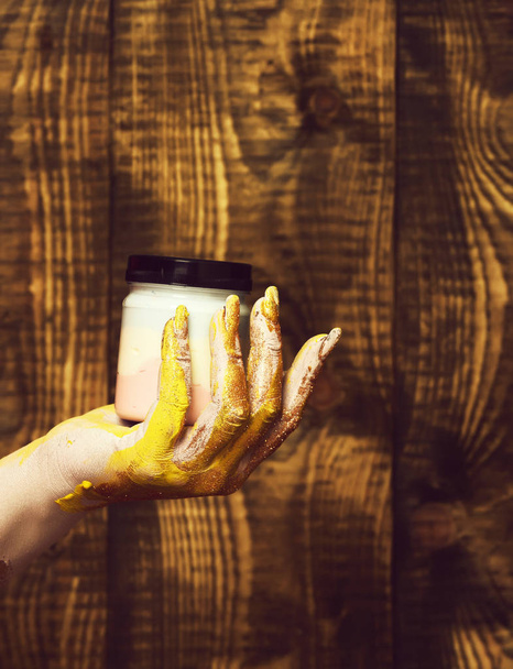 female hand holding jar - 写真・画像